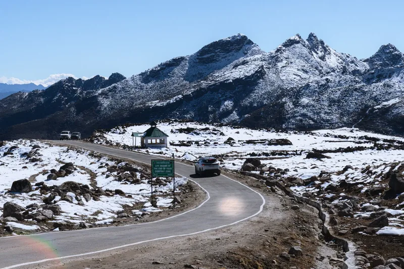 The road climbing through a snow-bound mountain pass