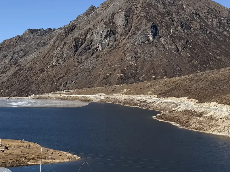 PT Tso Lake's still water below the pass road, ringed by bare peaks