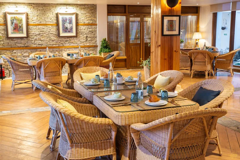 Dining tables set in wicker and glass before the light comes up
