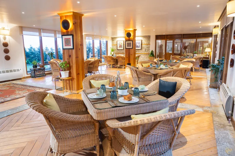 The dining room at golden hour, tables set and waiting