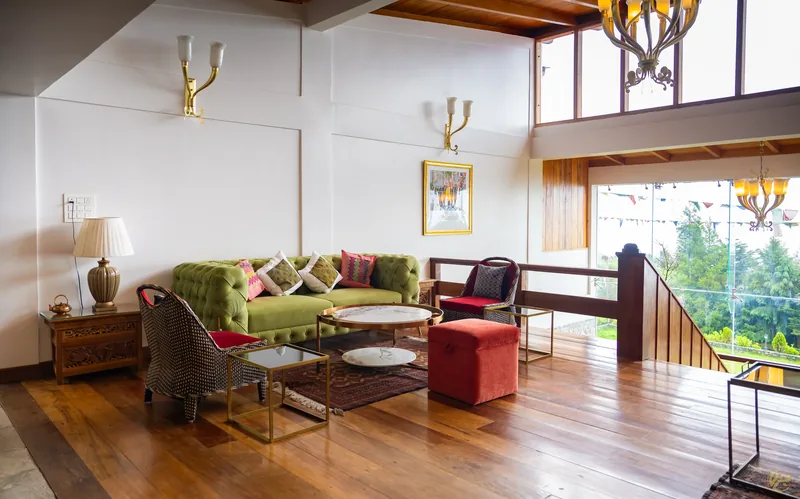 A sitting room with green sofas and trophy wall decor