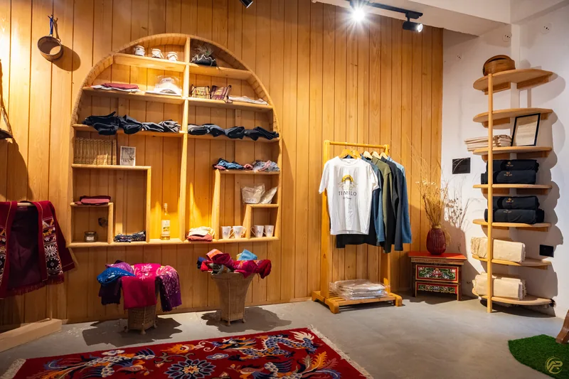 Shelves of Timilo-branded clothing and gifts in the souvenir shop