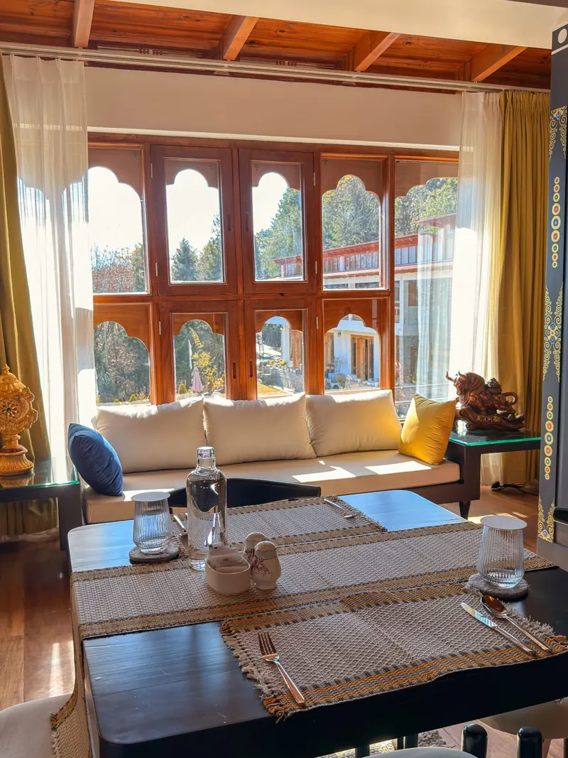 The dining table beneath the arched windows — Presidential Suite, Timilo Boutique