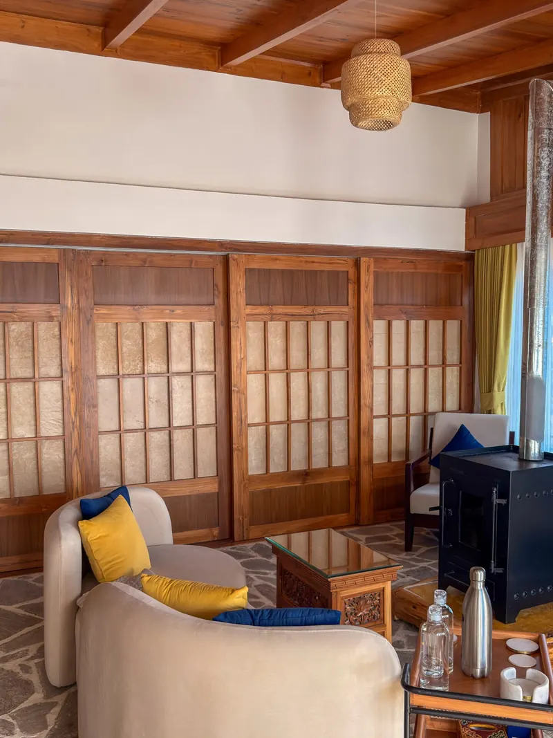 Shoji screens folded back from the reading chair — Presidential Suite, Timilo Boutique