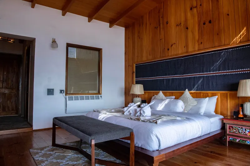 A hand-woven headboard and the bench at the foot of the beds — Timilo Royal Double, Timilo Boutique