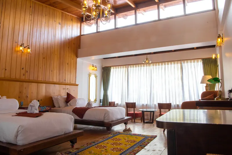 Twin beds, a writing table and the window wall behind — Timilo Royal Twin, Timilo Boutique